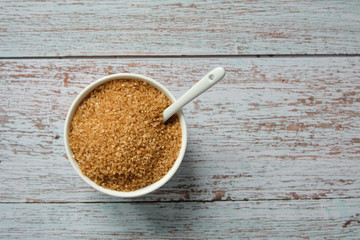 Top view of bowl full of brown sugar cane. Unhealthy ingredient. Copy space