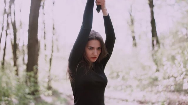 Portrait of a pretty girl with a samurai sword .Girl with a samurai sword fought at sunset.martial arts
