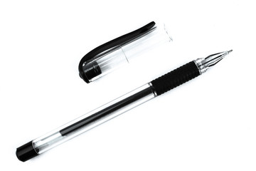 A black colored ball point pen and its cap scattered on top of a white background