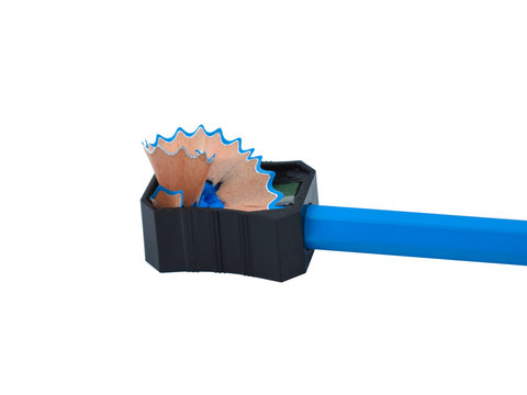 Blue color wood pencil crayon placed inside a pencil sharpener and some shavings