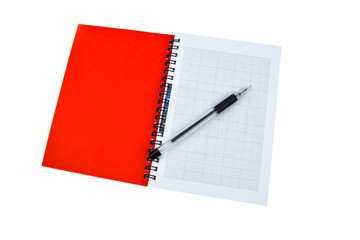 Red colored note paper diary and a black colored ball point pen placed together
