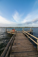 Fototapeta premium beautiful lake scene with row boat and golden evening sun, calming effect, romatic landscape