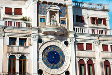 Fototapeta na wymiar The astronomical clock of Venice is the medieval mechanical clock tower with stars and a marble white Lion on the Piazza San Marco in Veneto, Italy. The original name is Torre dell'Orologio.