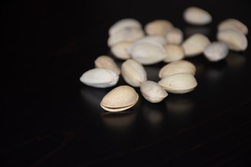 Pistachios on a dark wooden background