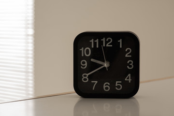 Black clock isolated against white background