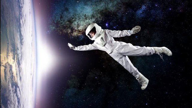Astronaut in space, in zero gravity near the planet Earth. The concept is to find a new earth. Elements of this image furnished by NASA.