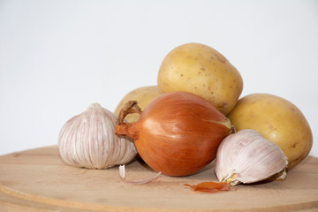 Vegetables on wooden board with white background