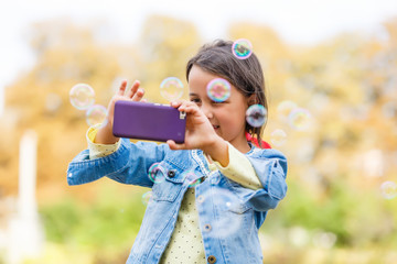 Video streaming. Adorable child learning new technology. Little girl using mobile phone. Small girl child with smartphone. Cute mobile phone technology user. Watching video on mobile device.