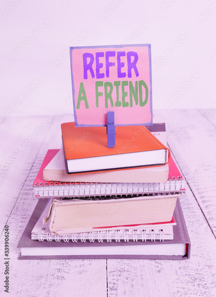 Aufkleber writing note showing refer a friend. business concept for direct someone to another or send him some