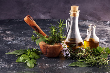 Homegrown and aromatic herbs on rustic background with rosemary and basil