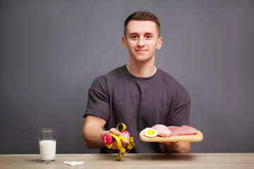 Man consumes a high-protein meal of meat and fruit