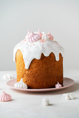 Happy Easter card with traditional cake decorated with original meringues on top in pink tones background