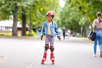 Little girl in roller skates at a park