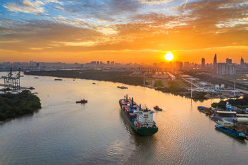 Fototapeta premium Aerial view of center Ho Chi Minh City, Vietnam with development buildings, transportation, energy power infrastructure. View from the Saigon river with ships on the river. 