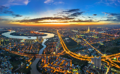 Top view aerial of Mai Chi Tho road, Thu Thiem peninsula and center Ho Chi Minh City, Vietnam  with development buildings, transportation, energy power infrastructure. View from District 2
