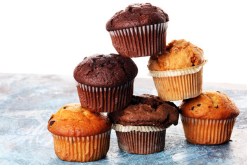 Chocolate muffin and nut muffin, homemade bakery on background.