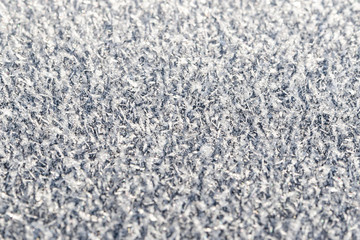 The surface is covered with hoarfrost, closeup, selective focus.
