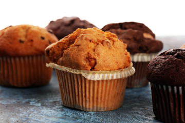 Chocolate muffin and nut muffin, homemade bakery on background.