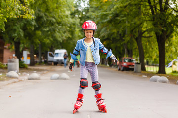 Little girl in roller skates at a park