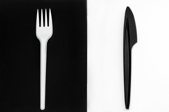 White Fork And Black Knife. Fork On A Black Background, Knife On A White Background.