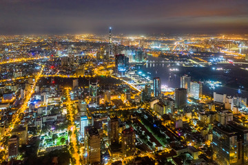 Fototapeta premium Top view aerial of Thu Thiem peninsula and center Ho Chi Minh City with development buildings, transportation, energy power infrastructure. Financial and business centers in developed Vietnam