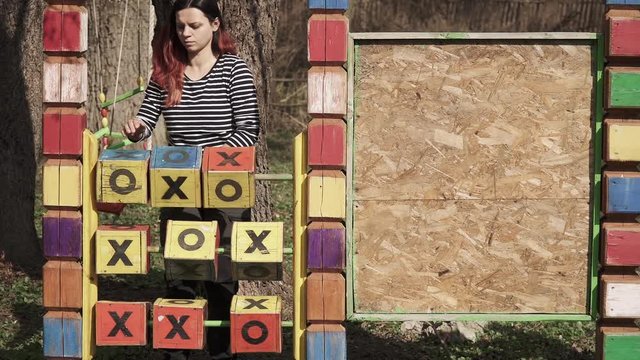 Girl plays wooden tic tac