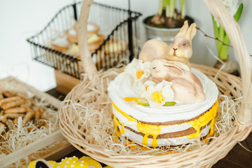 cake with hares and a white and yellow cake on the table