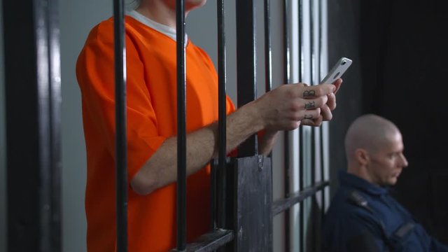 Prisoner allowed to use smartphone. Close up