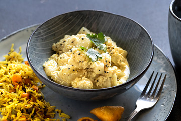 Oriental food - traditional Indian vegetarian dish of Bottle Gourd vegetable or Doodhi called Lauki Sabji. indian cuisine. Indian coconut Curry with ingredients in black background close-up, top view.