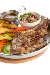 steak with vegetables in a plate on a white background isolate