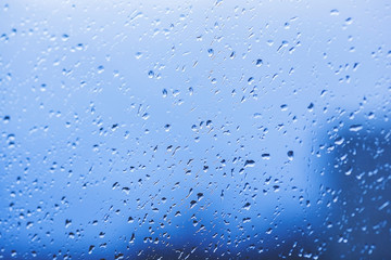 Drops of rain on the window. Water on the glass. Running drops. Background conceptual.