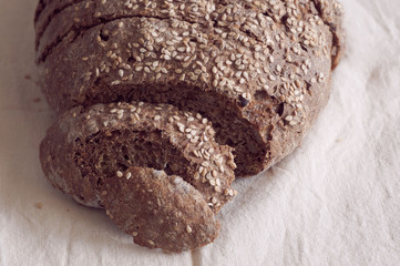 Freshly baked bread with cereal seads close up on natural background