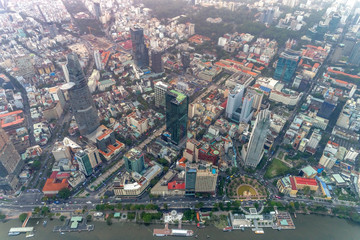 Fototapeta na wymiar Top view aerial photo from flying drone of a Ho Chi Minh City with development buildings, transportation, energy power infrastructure. Financial and business centers in developed Vietnam.