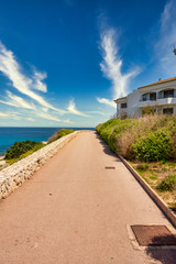 Way alongside holiday apartments on the spanish balearic island Mallorca near cala ratjada with view to the Mediterranean Sea
