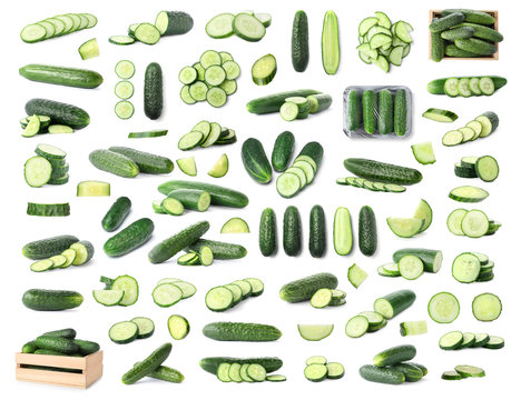 Set with whole and sliced cucumbers on white background