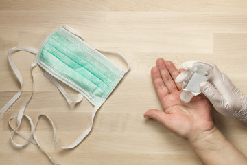 Surgical medical mask and hand being sanitized from top view