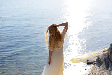 Fototapeta na wymiar Blonde model on the sea at summer 