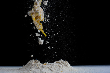 making a small piece of dough on a white surface