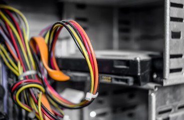 Multi-colored cable inside a computer processor. Cables close up on metal background