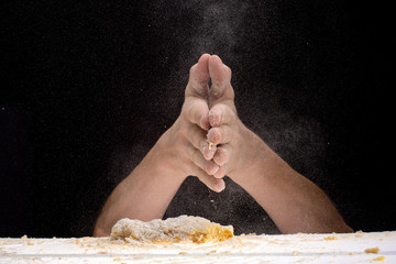 slap of hands with flour and suspension, haze in the air over the dough