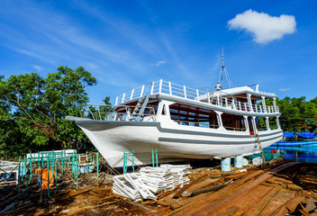 Worker in Shipyard. Shipyard industry ,( ship building) Big ship on floating dry dock in shipyard,...