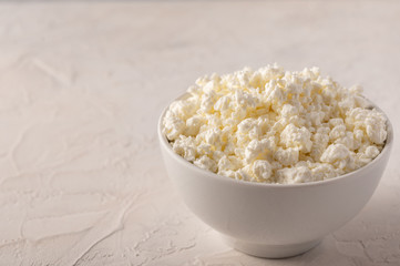 Curd in a bowl close-up on a light background