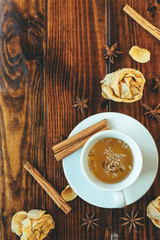 Cup of tea, cinnamon and anise on a wooden table