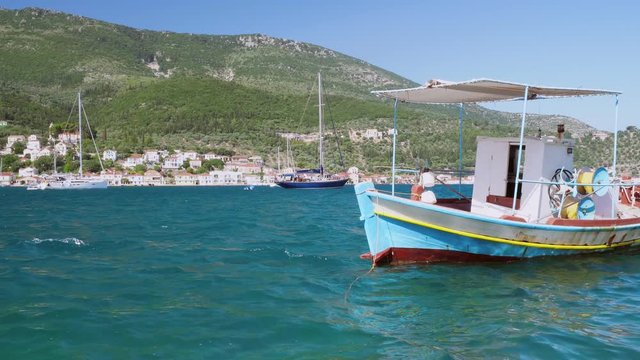 4k video of bobbing boat in the harbour. Greece Ithaki island, traditional wooden fishing boats at ithaka island at summer day