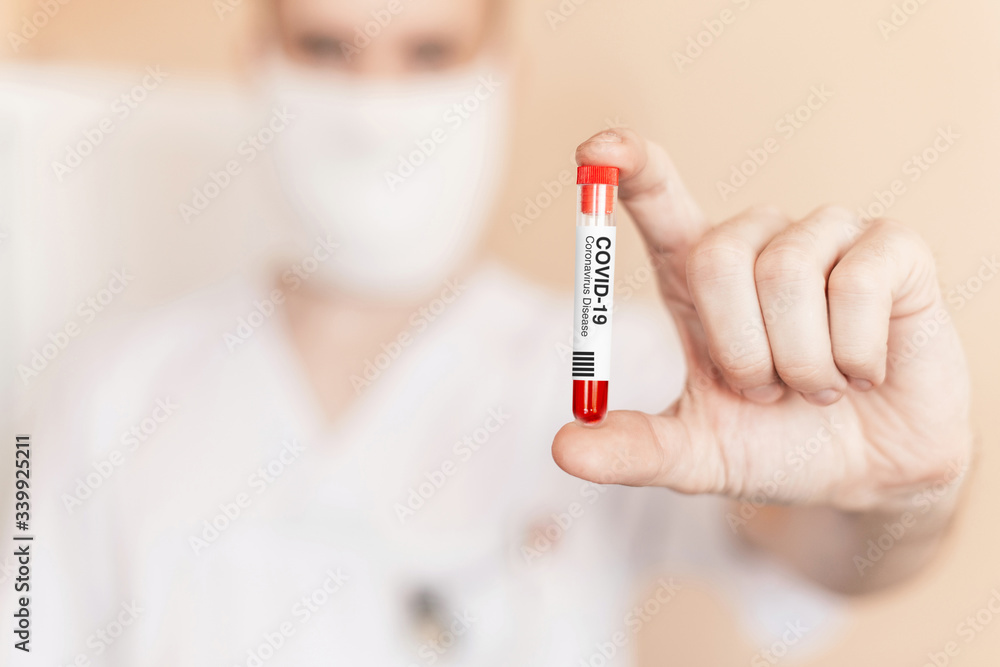 Wall mural Doctor holds in hand a test tube with coronavirus. COVID-19 Infectious Disease Vaccine. Antidote