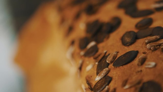 Close up of homemade bread with pampkin seeds baking in the owen. Slow motion shot with shallow focus