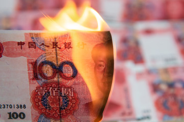 Burning Chinese yuan as symbol economic recession..
