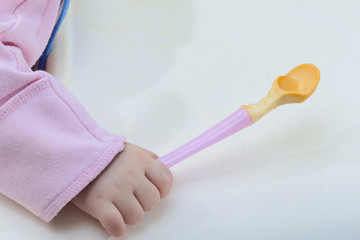 sleeping baby with spoon in his hands fell asleep during eating