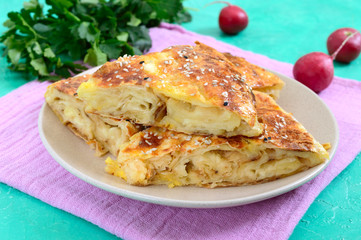 Burek Turkish pie. Lavash puff pie with cheese and sesame seeds
