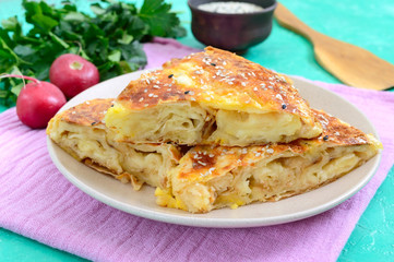 Burek Turkish pie. Lavash puff pie with cheese and sesame seeds